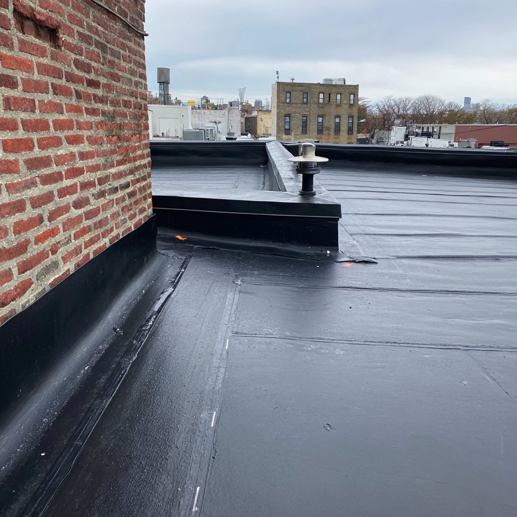 Black EPDM rubber membrane on a Brooklyn commercial roof with new lap seams and flashing