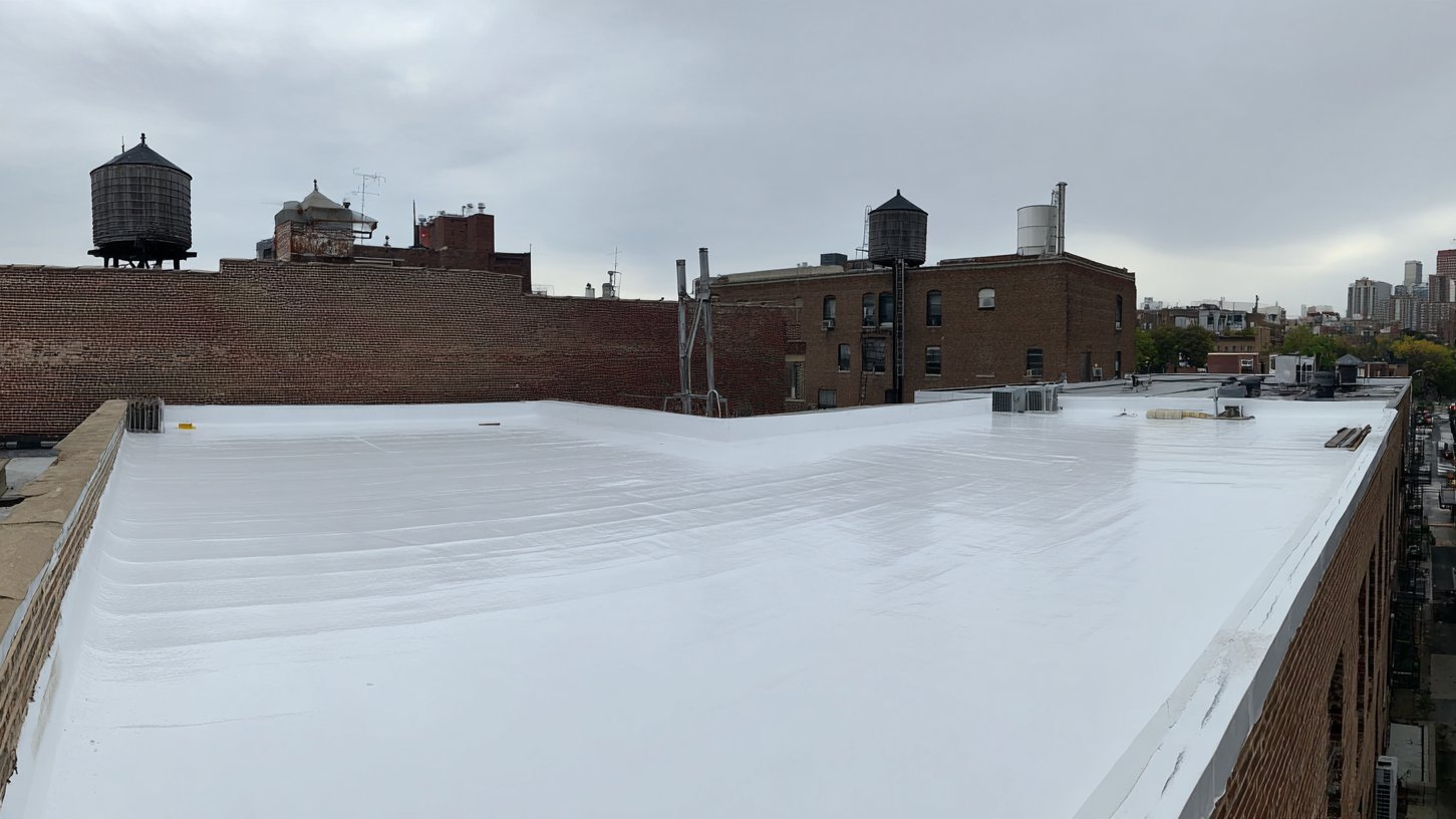 Brooklyn commercial flat roof freshly coated in a seamless white reflective acrylic membrane