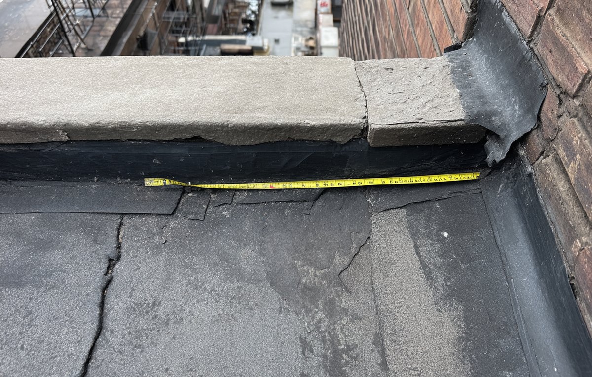 Patched seam and new flashing on a worn EPDM roof in Brooklyn, measured for a repair estimate